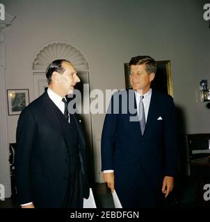 Meeting with the Ambassador of Great Britain, Sir David Ormsby-Gore, 6:15 PM. President John F. Kennedy meets with Ambassador of Great Britain, Sir David Ormsby-Gore. Ambassador Ormsby-Gore; President Kennedy. Oval Office, White House, Washington, D.C. Stock Photo