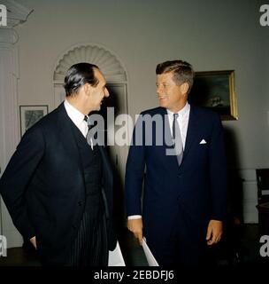 Meeting with the Ambassador of Great Britain, Sir David Ormsby-Gore, 6:15 PM. President John F. Kennedy meets with Ambassador of Great Britain, Sir David Ormsby-Gore. Ambassador Ormsby-Gore; President Kennedy. Oval Office, White House, Washington, D.C. Stock Photo