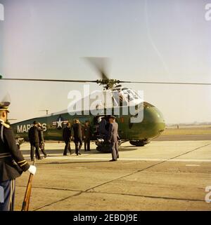 Arrival ceremonies for William Vacanarat Shadrach Tubman, President of Liberia, 10:00 AM. Arrival ceremonies for William V.S. Tubman, President of Liberia. President Tubman and President John F. Kennedy (center, backs to camera) approach United States Marine Corps helicopter. Others unidentified. Andrews Air Force Base, Maryland. Stock Photo