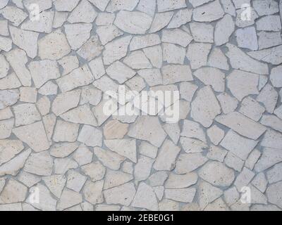 The wall is lined with light gray beige decorative tiles of various shapes. Full screen photo. Stock Photo