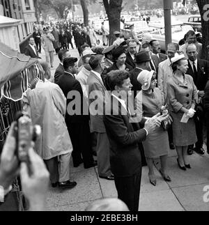 Arrival ceremonies for Dr. Manuel Prado Ugarteche, President of Peru 12:00PM. President John F. Kennedy stands and claps on the sidewalk outside Blair House, Washington, D.C. Also pictured: Claribel Berckemeyer, wife of Ambassador of Peru, Fernando Berckemeyer; United States Ambassador to Peru James Loeb; United States Chief of Protocol Angier Biddle Duke (mostly hidden behind Ambassador Loeb); Ambassador of Peru Fernando Berckemeyer; Virginia Rusk, wife of Secretary of State Dean Rusk; and Washington political reporter for the New York Times, Tom Wicker. Stock Photo