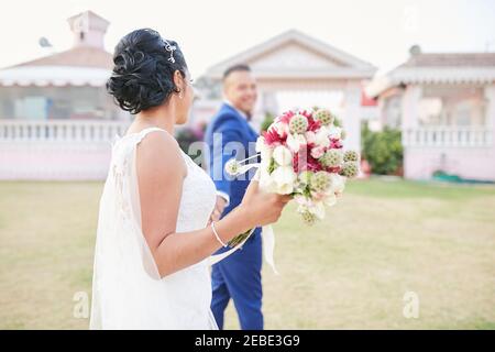 view from the back of a newly married couple holding hands Stock Photo