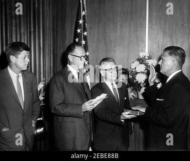 Swearing-in ceremony, James J. Rowley, Director of the Secret Service, 10:37AM. President John F. Kennedy attends the swearing-in ceremony for new Secret Service Director, James J. Rowley, at the Treasury Department, Washington, D.C. (L-R) President Kennedy; Secretary of the Treasury C. Douglas Dillon; unidentified clerk (holding Bible); Director Rowleyu2019s daughter Donna Rowley (partially hidden); Director Rowley. Stock Photo