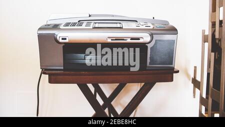 home printer leaning on a wooden stool Stock Photo
