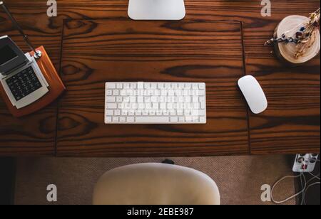 shot of table computer with mouse and keyboard on wooden table Stock Photo
