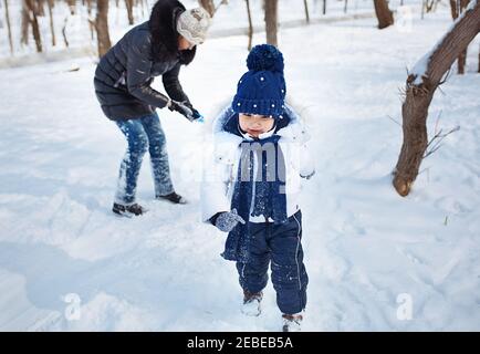 Mother and child in winter forest Stock Photo
