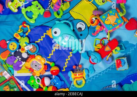 Russia. Saint-Petersburg. 2021.01.20. Colourful assorted baby toys. Different animals on saturated blue baby education map. Top view.  Stock Photo