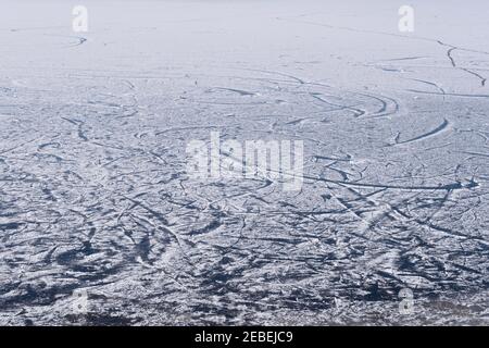 Surface of a frozen lake covered with snow and a pattern of skating tracks Stock Photo