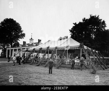 Dinner at Mount Vernon in honor of Muhammad Ayub Khan, President of Pakistan, 7:45PM. State dinner in honor of President Mohammad Ayub Khan of Pakistan. Several unidentified people outside of marquee. Mount Vernon, Virginia. Stock Photo