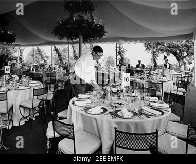 Dinner at Mount Vernon in honor of Muhammad Ayub Khan, President of Pakistan, 7:45PM. State dinner in honor of President Mohammad Ayub Khan of Pakistan. Chief Gardener of the White House, Robert M. Redmond, sets tables in marquee. Mount Vernon, Virginia. Stock Photo