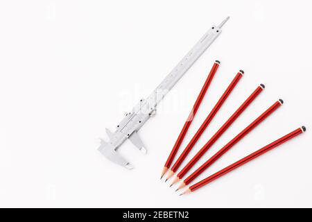 Analog Vernier Caliper with Group of Five Pencils Isolated on White Background Stock Photo
