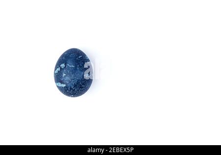 One chicken egg is dark blue on a white background. Stock Photo