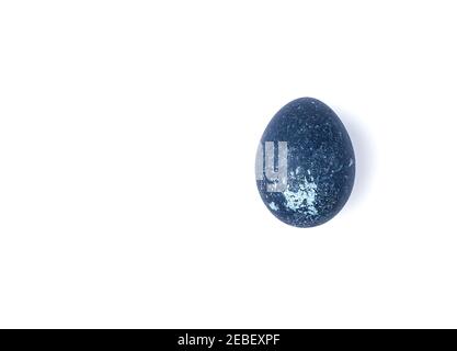 The chicken egg is colored with natural dyes, isolated on white. Stock Photo