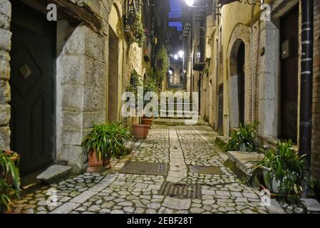 A narrow street between the old houses of Guardia Sanframondi, a medieval village in the province of Benevento, Italy. Stock Photo