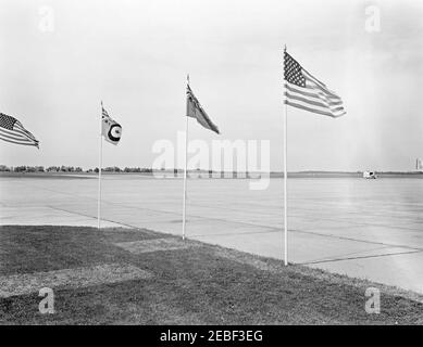 Trip to Ottawa, Canada: Departure ceremonies, 9:45AM. Two American Flags, the Flag of the Royal Canadian Air Force (RCAF), and the Canadian Red Ensign flying at the RCAF Station Uplands, Ottawa, Ontario, Canada. [Photograph by Harold Sellers] Stock Photo