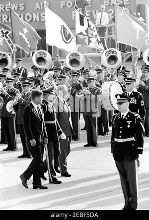 Arrival ceremonies for Harold Macmillan, Prime Minister of Great Britain, 4:50PM. Commander of Troops, Lieutenant Colonel Charles P. Murray, Jr. (center left), escorts President John F. Kennedy and Prime Minister of Great Britain, Harold Macmillan, past an unidentified military band during arrival ceremonies for Prime Minister Macmillan. Andrews Air Force Base, Maryland.