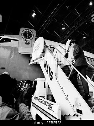 President Kennedy departs Andrews Air Force Base for West Palm Beach, Florida, 12:10PM. President John F. Kennedy (wearing a hat) and First Lady Jacqueline Kennedy board Air Force One inside hangar at Andrews Air Force Base in Maryland, for flight to West Palm Beach, Florida. Stock Photo