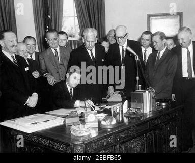 Bill Signing u2013 S.1 Public Law 87-27 Area Redevelopment Act, 11:08AM. Bill Signing u2013 S.1 Public Law 87-27 Area Redevelopment Act. President John F. Kennedy sits at desk. Looking on (L-R): Congressman Daniel J. Flood (Pennsylvania); Congressman Cleveland M. Bailey (West Virginia); Senator Hubert Humphrey (Minnesota); Vice President Lyndon B. Johnson; Congressman Frank Stubblefield (Kentucky); Senator Paul H. Douglas (Illinois); Congressman Frank Chelf (Kentucky), behind Douglasu2019 shoulder; Senator John Sherman Cooper (Kentucky), in back; Congressman Brent Spence (Kentucky); Senator Stock Photo