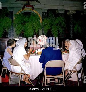 First Lady Jacqueline Kennedy (JBK) attends the Senate Ladies Red Cross Unit Luncheon. First Lady Jacqueline Kennedy attends a luncheon for members of the Senate Ladies Red Cross Unit in the Old Supreme Court Chamber, United States Capitol Building, Washington, D.C. The Red Cross unit (also known as u201cLadies of the Senateu201d) is comprised of the wives of members of the US Senate. Left to right: Senator Maurine Neuberger (Oregon); Noel Clark (wife of Senator Joseph S. Clark of Pennsylvania); Mrs. Kennedy; Ilo Browne Wallace (wife of former Vice President Henry A. Wallace); Lady Bird John Stock Photo