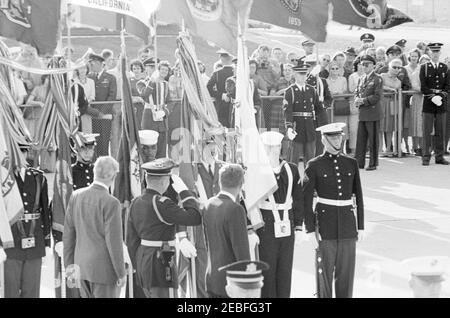 Arrival ceremonies for Harold Macmillan, Prime Minister of Great Britain, 4:50PM. Commander of Troops, Lieutenant Colonel Charles P. Murray, Jr. (center left, saluting), escorts President John F. Kennedy and Prime Minister of Great Britain, Harold Macmillan, past military color and honor guards during arrival ceremonies for Prime Minister Macmillan. Andrews Air Force Base, Maryland.