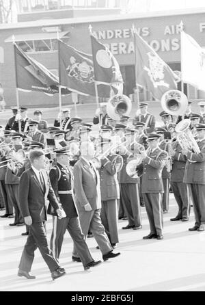 Arrival ceremonies for Harold Macmillan, Prime Minister of Great Britain, 4:50PM. Commander of Troops, Lieutenant Colonel Charles P. Murray, Jr. (left), escorts President John F. Kennedy and Prime Minister of Great Britain, Harold Macmillan, past an unidentified military band during arrival ceremonies for Prime Minister Macmillan. Andrews Air Force Base, Maryland.