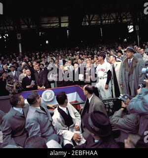 Opening Day of the 1961 Baseball Season, 1:10PM. President John F. Kennedy throws the first pitch of the 1961 baseball season at Griffith Stadium, Washington, D.C. Those looking on include Vice President Lyndon B. Johnson; Secretary of the Interior Stewart Udall; Secretary of Agriculture Orville Freeman; Boys Clubs of Americau0027s u0022Boy of the Yearu0022 Richard Lopez; Senator Hubert Humphrey of Minnesota; Representative Carl Albert of Oklahoma; Representative Charles Halleck of Indiana; Senate Majority Leader Mike Mansfield of Montana; Special Assistant to the President Dave Powers; maj Stock Photo