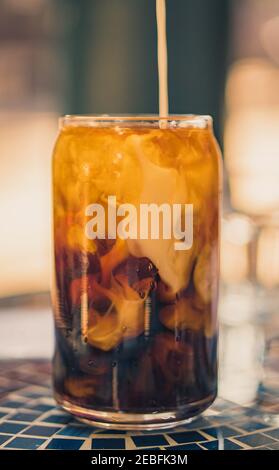 Coffee Cold Brew with Milk Being Poured Stock Photo