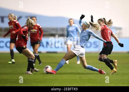 Manchester City's Chloe Kelly (centre) battles for the ball with Manchester United's Jackie Groenen (left) and Ona Batlle during the FA Women's Super League match at the Academy Stadium, Manchester. Picture date: Friday February 12, 2021. Stock Photo