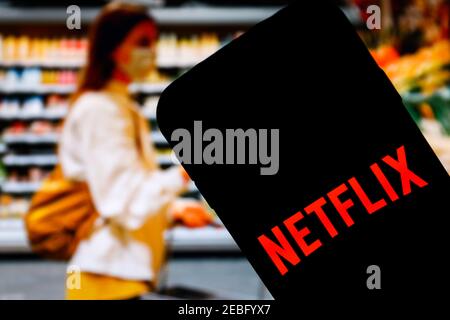 In this photo illustration a Netflix online streaming company app logo seen displayed on a smartphone. Stock Photo