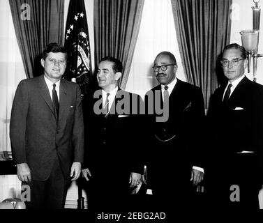 Meeting with the West Indian Base Agreement Delegation, 11:55AM. President John F. Kennedy meets with the delegation representing the United States in defense negotiations with the Federation of the West Indies; Oval Office, White House, Washington, D.C. (L-R) President Kennedy; representative of the United States Dr. Hector Garcia; Special Assistant to the Secretary of Labor George Weaver; former Ambassador to Great Britain and chairman of the United States delegation John Hay Whitney. Stock Photo