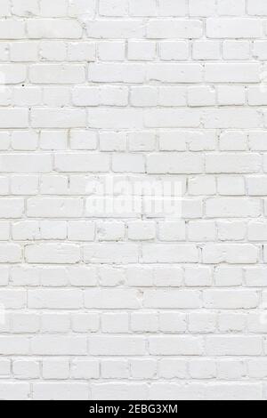 White painted brick wall. White background of bricks. Bricks whitewall. Abstract texture background. Vertical orientation. Stock Photo