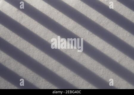 the abstract photography with the shadow line of balcony on snowdrift Stock Photo