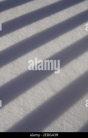 the abstract photography with the shadow line of balcony on snowdrift Stock Photo