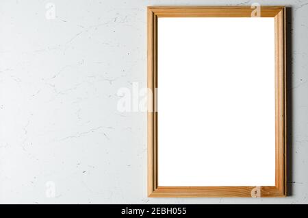 Mockup. An empty wooden photo frame on a textured gray wall. Stock Photo