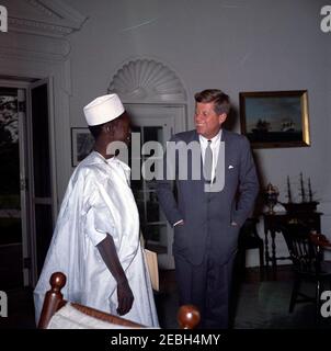 Meeting with the Ambassador of Mali, Oumar Sow, 12:08PM. President John F. Kennedy meets with the newly-appointed Ambassador of the Republic of Mali, Oumar Sow (left). Ambassador Sow presented his credentials to President Kennedy. Oval Office, White House, Washington, D.C. Stock Photo