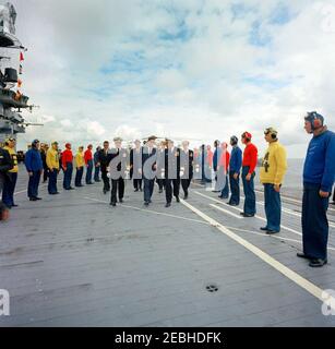 Trip to Western States: Visit to the Pacific Fleet, President Kennedy aboard the USS Oriskany, 4:00PM. President John F. Kennedy (center, wearing sunglasses) and others walk past members of the USS Oriskany (CVA-34) flight deck crew after President Kennedyu0027s arrival aboard the aircraft carrier, during a visit to the U.S. Pacific Fleet at sea off the coast of San Diego, California. Commander-in-Chief of the Pacific Fleet (CINCPACFLT), Admiral John H. Sides, and Commander of Carrier Division One, Rear Admiral Paul Masterton, walk to the left and right (respectively) of the President. Follow Stock Photo