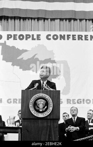Conservation Tour of Western States: Minnesota, Duluth: President Kennedy Addresses Northern Great Lakes Region Land and People Conference at the University of Minnesota, Duluth, 7:20PM. President John F. Kennedy (at lectern) addresses the Northern Great Lakes Region Land and People Conference. Senator Hubert H. Humphrey (Minnesota) sits behind President Kennedy at right; others are unidentified. University of Minnesota Duluth Field House, Duluth, Minnesota.