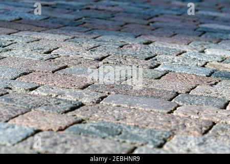 stone pavement texture, granite cobblestoned pavement background, abstract background of old cobblestone pavement close-up Stock Photo