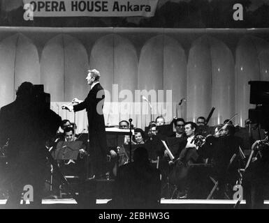 National Cultural Center Fund-raising benefit, 9:23PM. Entertainer, Danny Kaye, conducts the National Symphony Orchestra during a fundraising dinner and closed-circuit telecast of u0022An American Pageant of the Artsu0022 for the National Cultural Center. National Guard Armory, Washington, D.C. Stock Photo