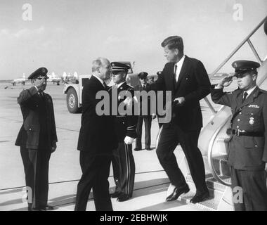 President Kennedy returns to Andrews Air Force Base from Easter vacation, 4:33PM. President John F. Kennedy (holding hat) shakes hands with Secretary of State, Dean Rusk, upon his arrival aboard Air Force One at Andrews Air Force Base, Maryland, following Easter vacation in Palm Beach, Florida.