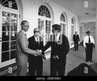 Meeting with members of the Senior Seminar in Foreign Policy of the Foreign Service Institute, 3:30PM. President John F. Kennedy shakes hands with an unidentified man during a meeting with members of the Senior Seminar in Foreign Policy of the Foreign Service Institute (FSI); Director of FSI, Carl W. Strom, stands in center. Standing in background are Special Assistant to the President, Kenneth P. Ou2019Donnell, and an unidentified White House Police officer. West Wing Colonnade, White House, Washington, D.C. Stock Photo
