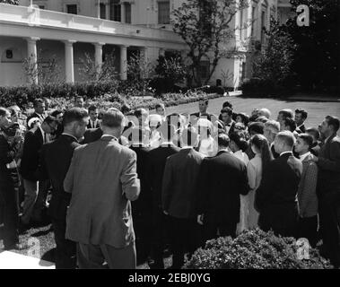Visit of a delegation from the Foundation for the Junior Blind, 10:04AM. President John F. Kennedy (center left) visits with delegates from the Foundation for the Junior Blind, of Los Angeles, California. White House Police officer, Inspector Kenneth M. Burke (in back, partially hidden), stands in crowd at left. Rose Garden, White House, Washington, D.C. Stock Photo