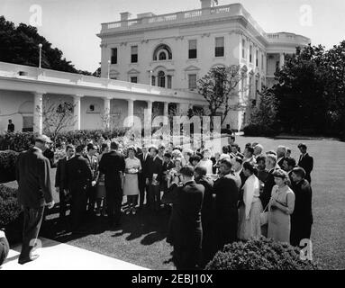 Visit of a delegation from the Foundation for the Junior Blind, 10:04AM. President John F. Kennedy (center left, back to camera) visits with delegates from the Foundation for the Junior Blind, of Los Angeles, California. Representative James Roosevelt (California) stands on steps at far left. Rose Garden, White House, Washington, D.C. Stock Photo
