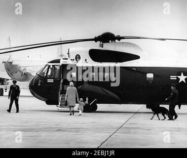 President Kennedy arrives at Andrews Air Force Base from Palm Beach, Florida, 3:43PM. First Lady Jacqueline Kennedy and John F. Kennedy, Jr., walk towards a United States Army helicopter, following their arrival at Andrews Air Force Base from Palm Beach, Florida. Maryland. Stock Photo