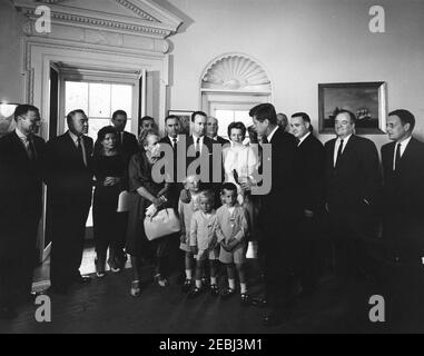 Presentation of the Thomas A. Dooley III Medal to Mrs. Agnes Dooley, 10:04AM. President John F. Kennedy presents the posthumous Dr. Thomas A. Dooley III Congressional Gold Medal to Dr. Dooleyu2019s mother, Agnes Wise Dooley (center left). Also pictured: Executive Director of Medical International Cooperation Organization (MEDICO), Malcolm W. Dooley, and Gabrielle Dooley and their children, Malcolm Jr., Thomas, and Michael; Representative Henry S. Reuss (Wisconsin); Senator John A. Carroll (Colorado); Director of the U.S. Mint, Eva Adams; Senator Claiborne Pell (Rhode Island); Representative F Stock Photo