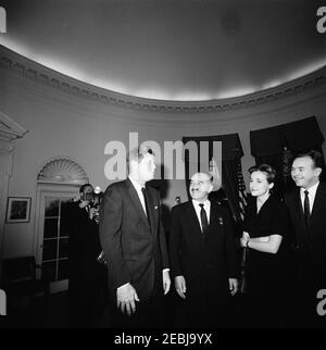 Meeting with Anastas Ivanovich Mikoyan, First Deputy Chairman of the Council of Ministers of the Soviet Union (USSR), 4:30PM. President John F. Kennedy meets with First Deputy Chairman of the Council of Ministers of the Soviet Union, Anastas Mikoyan (center right). Also pictured: U.S. State Department interpreter, Natalie Kushnir; United Press International (UPI) photographer, Frank Cancellare (mostly hidden). Oval Office, White House, Washington, D.C. Stock Photo