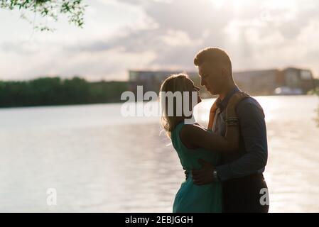 Silouette, loving couple on the lake during sunset Stock Photo