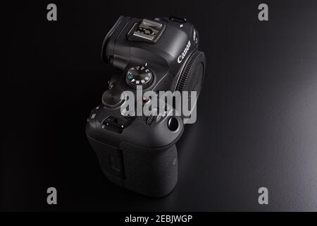 St. Petersburg, Russia - January 9, 2021: Canon EOS R6 full-frame mirrorless digital camera body on black background, top view. Stock Photo