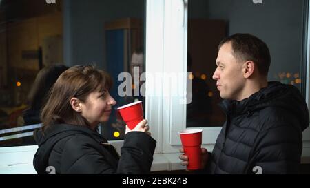 Young couple in the late evening drinking a drink on the balcony of glasses Stock Photo