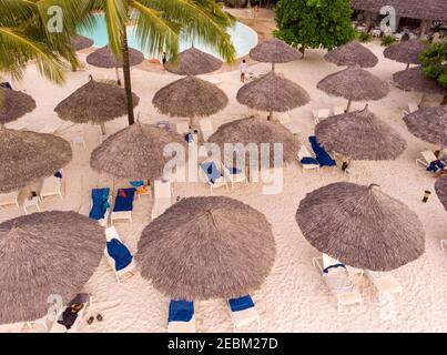 Aerial view of Thatched roofed beach umbrellas of luxury ocean view resort at the beautiful white sand ocean coast in Nungwi at Zanzibar island Stock Photo